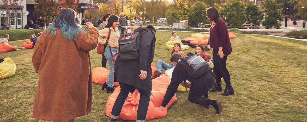 Students grab bean bags to sit on and catch up at the lawns in Kambri.