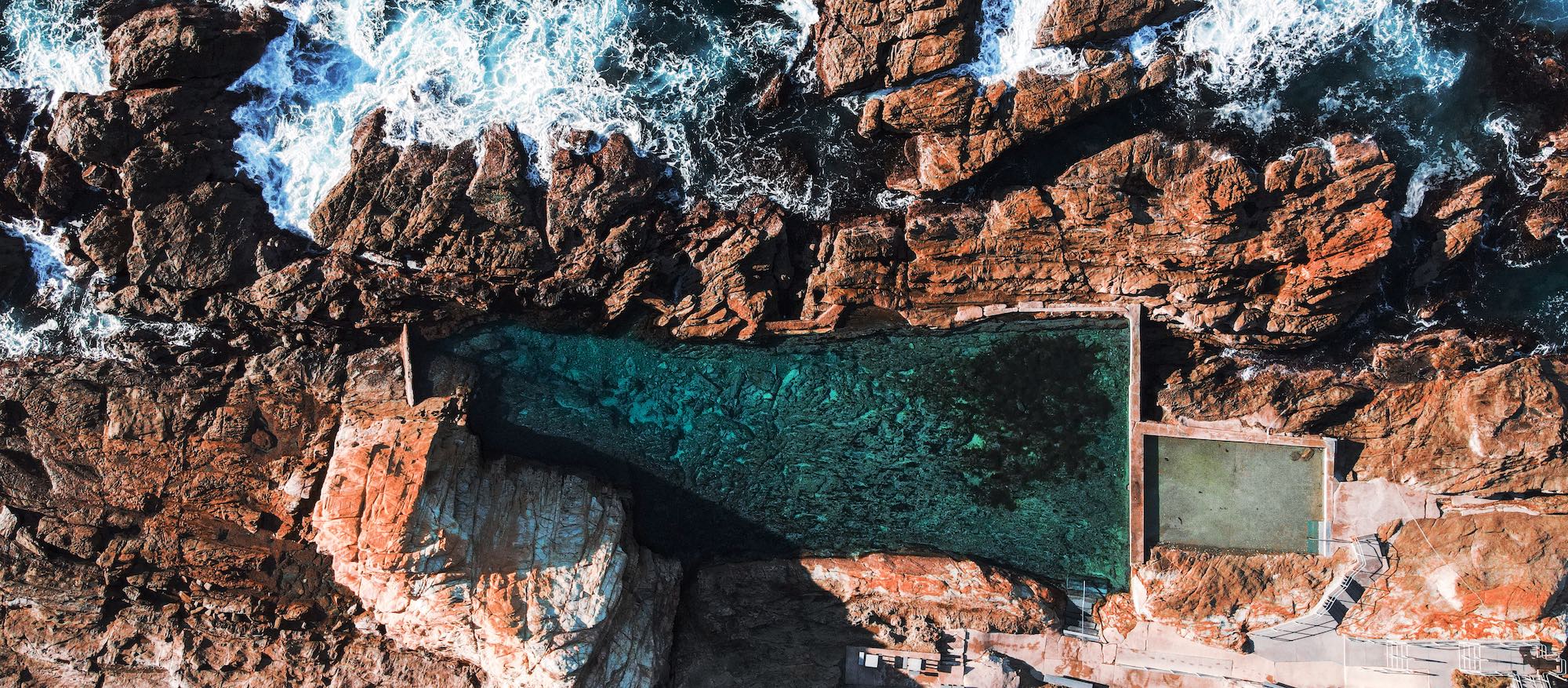 An aerial shot of the ocean-fed rock pool known as the Blue Pool in Bermagui.