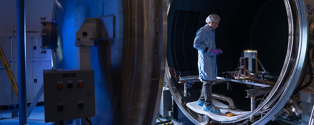 Technicians check over a satellite after undergoing a test at the Advanced Instrumentation Technology Centre